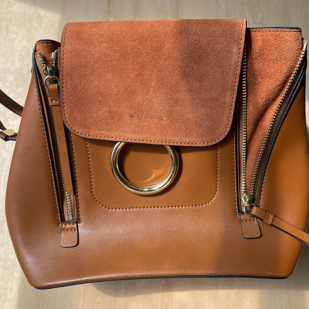 Gorgeous Vegan leather small convertible handbag.